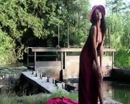 A Real Bombshell Poses For The Camera Outside In A Stream