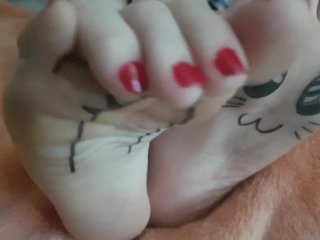 Kawaii japanese girl plays with her painted pale feet