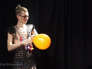 Nicky as a superhero destroys balloons