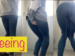 OL wearing jeans in front of a public toilet desperate to  pee