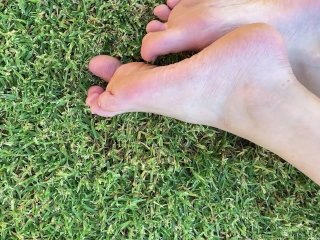 Playing with my feet and dirty toenails outside on grass