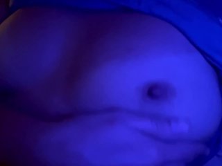 Lying in bed, playing with my firm tits and nipples