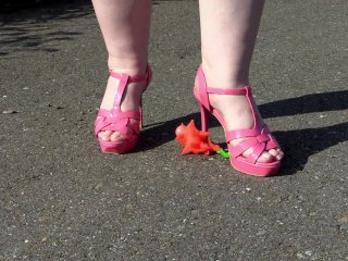 Crushes a toy with high heels.