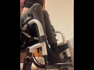 Disabled girl undressing in wheelchair